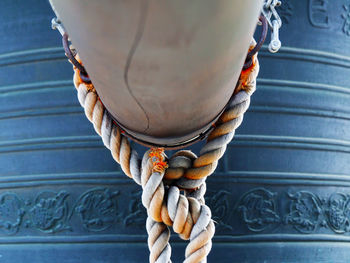 Rope tied to metallic bell at japanese temple