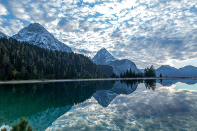 Idyllic shot of mountains against sky reflecting in lake