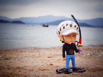 Cute boy with toy on beach