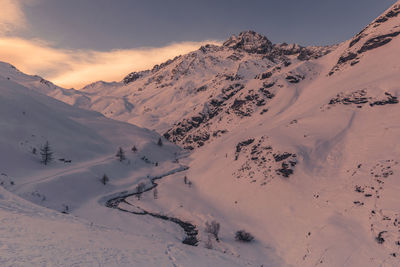 Scenic view of snow covered mountains against sky