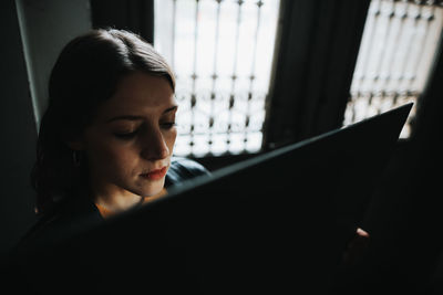 Portrait of young woman using mobile phone