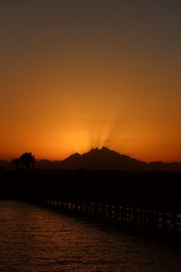 Scenic view of lake against orange sky