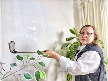Portrait of young woman holding bottle