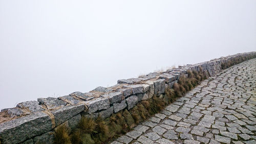 Stone wall against clear sky