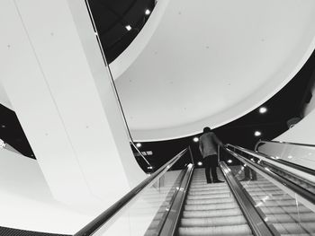 Man moving up on escalator at library of birmingham