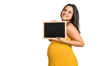 Portrait of a smiling young woman over white background