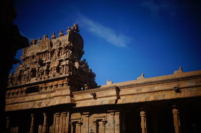 Low angle view of statue against blue sky