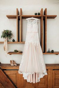 Wedding gown hanging on wall