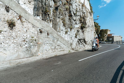 Man riding bicycle on road