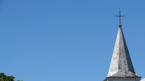 Low angle view of building against clear blue sky