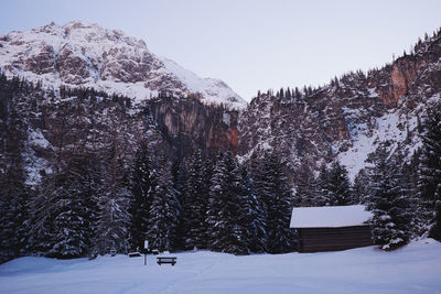 Snow covered landscape against clear sky