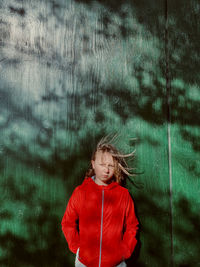 Portrait of girl standing at the wall 