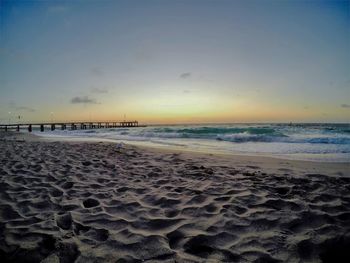 Scenic view of beach against sky during sunset