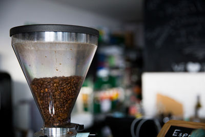 Close-up of raw coffee beans in grinder