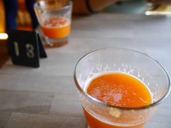 Close-up of orange juice on table