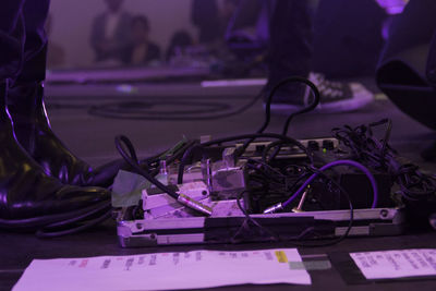 Low section of person standing by messy cables