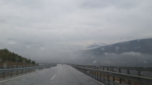 View of road against cloudy sky