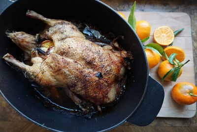 High angle view of chicken meat in cooking utensil on table