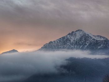 Scenic view of snowcapped mountains against sky during sunset