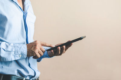 Midsection of man using mobile phone