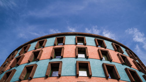 Low angle view of building against cloudy sky