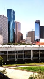 Buildings in city against clear sky