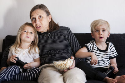 Grandmother with grandchildren playing video games
