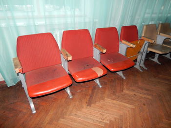 High angle view of old empty seats in row on hardwood floor