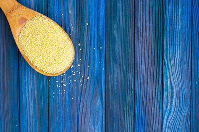 High angle view of yellow slices on blue table