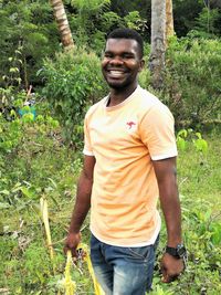 Portrait of smiling young man standing on land