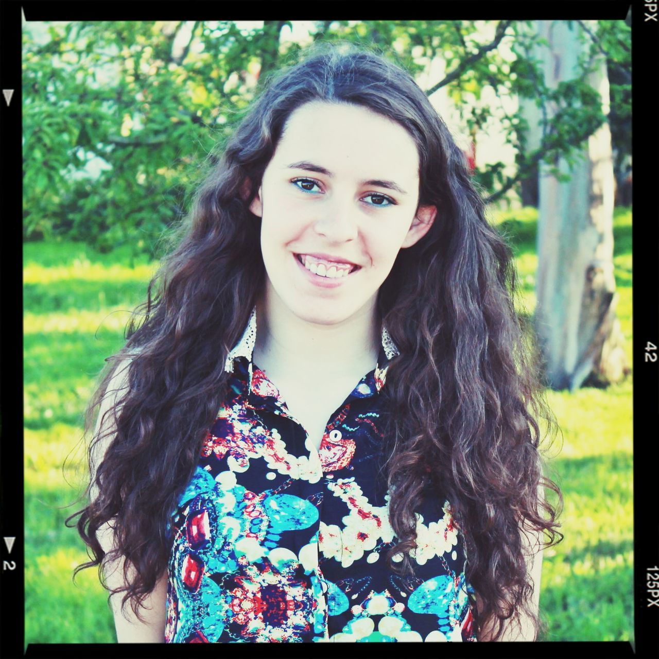 long hair, young women, young adult, transfer print, portrait, person, looking at camera, lifestyles, auto post production filter, leisure activity, front view, smiling, casual clothing, tree, brown hair, headshot, focus on foreground