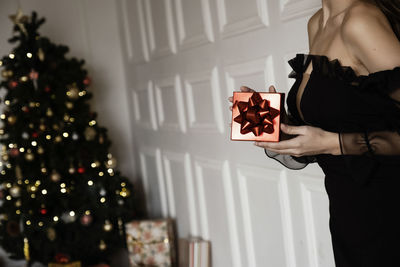 Midsection of woman holding christmas present