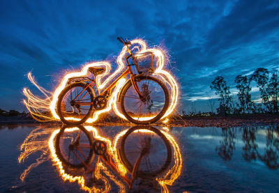 Light painting over bicycle by lake