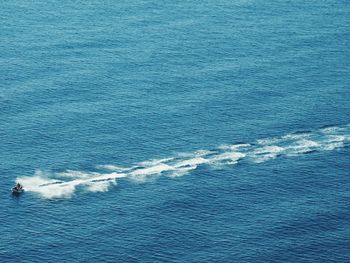 Aerial view of man riding jet boat on sea