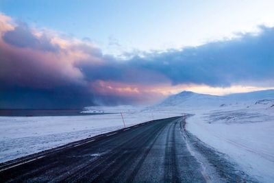 Scenic view of road against sky during winter