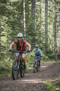 Two female bikers enjoy a trail in sandy, or near mt. hood.