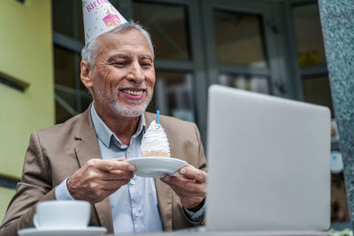 Portrait of man holding coffee cup