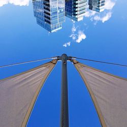 Low angle view of modern building against blue sky