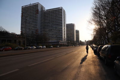 City street and buildings against sky