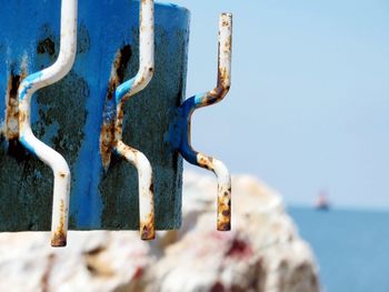 Close-up of padlocks against sea