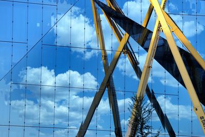 Low angle view of suspension bridge against sky