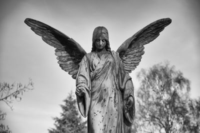 Low angle view of statue against sky