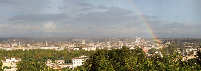 View of rainbow over buildings in city