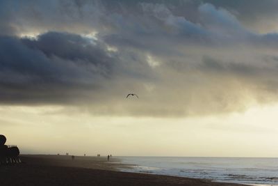 Scenic view of calm sea against cloudy sky