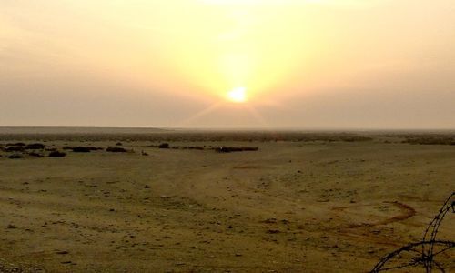 Scenic view of beach against sky during sunset