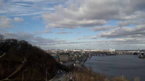 High angle view of buildings by sea against sky