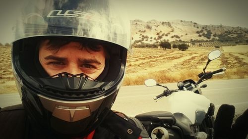 Close-up portrait of young woman riding motorcycle