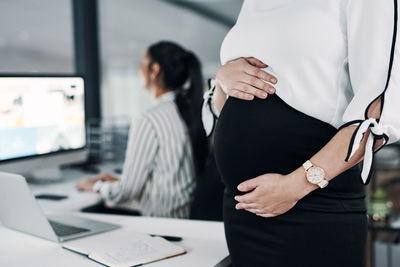 Midsection of woman using laptop