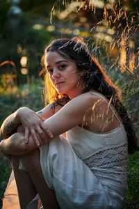 Side view of young woman lying on land