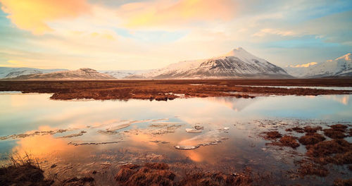 Scenic view of lake against cloudy sky